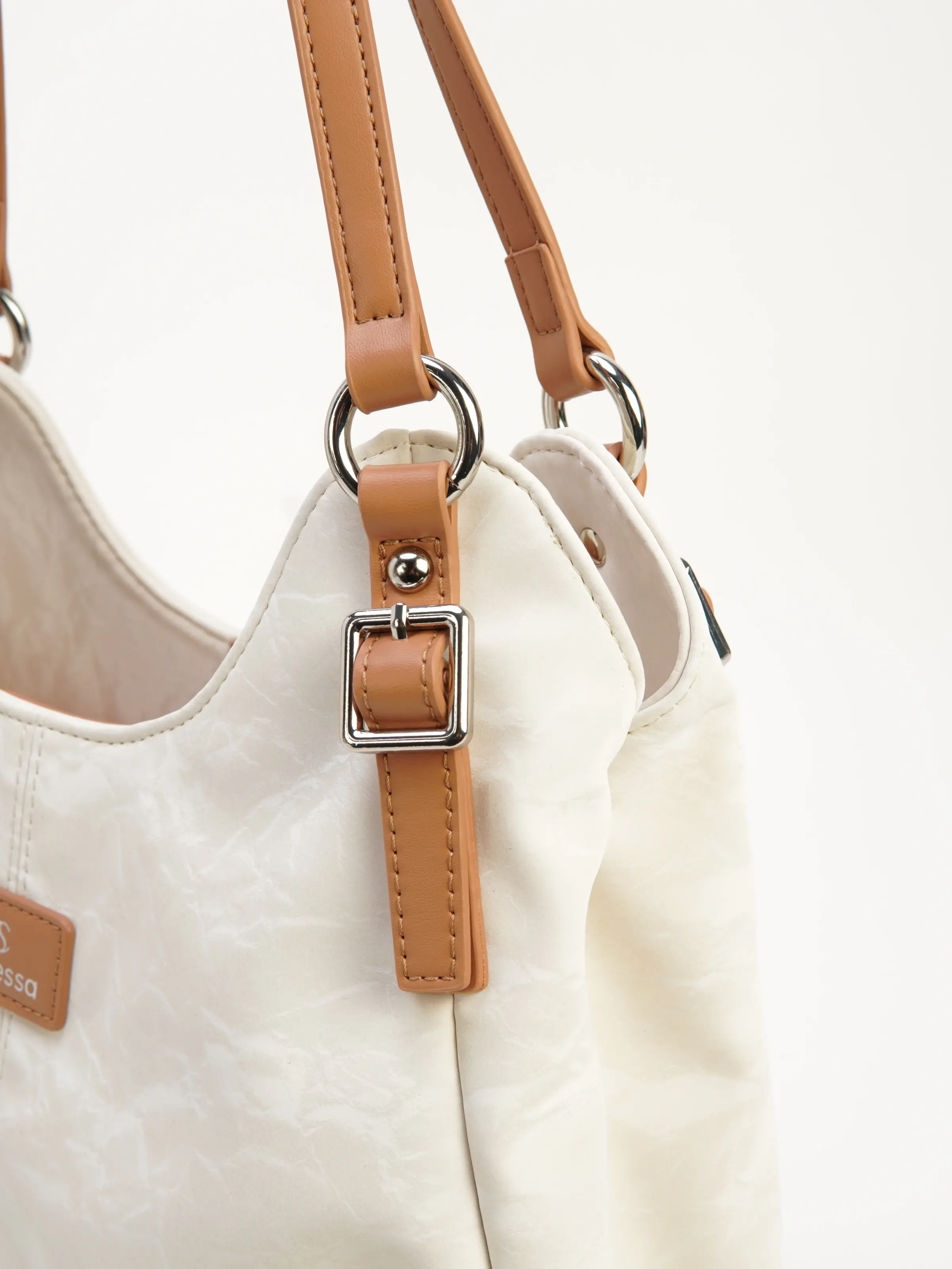 Close view of Elia tan strap and metal buckle