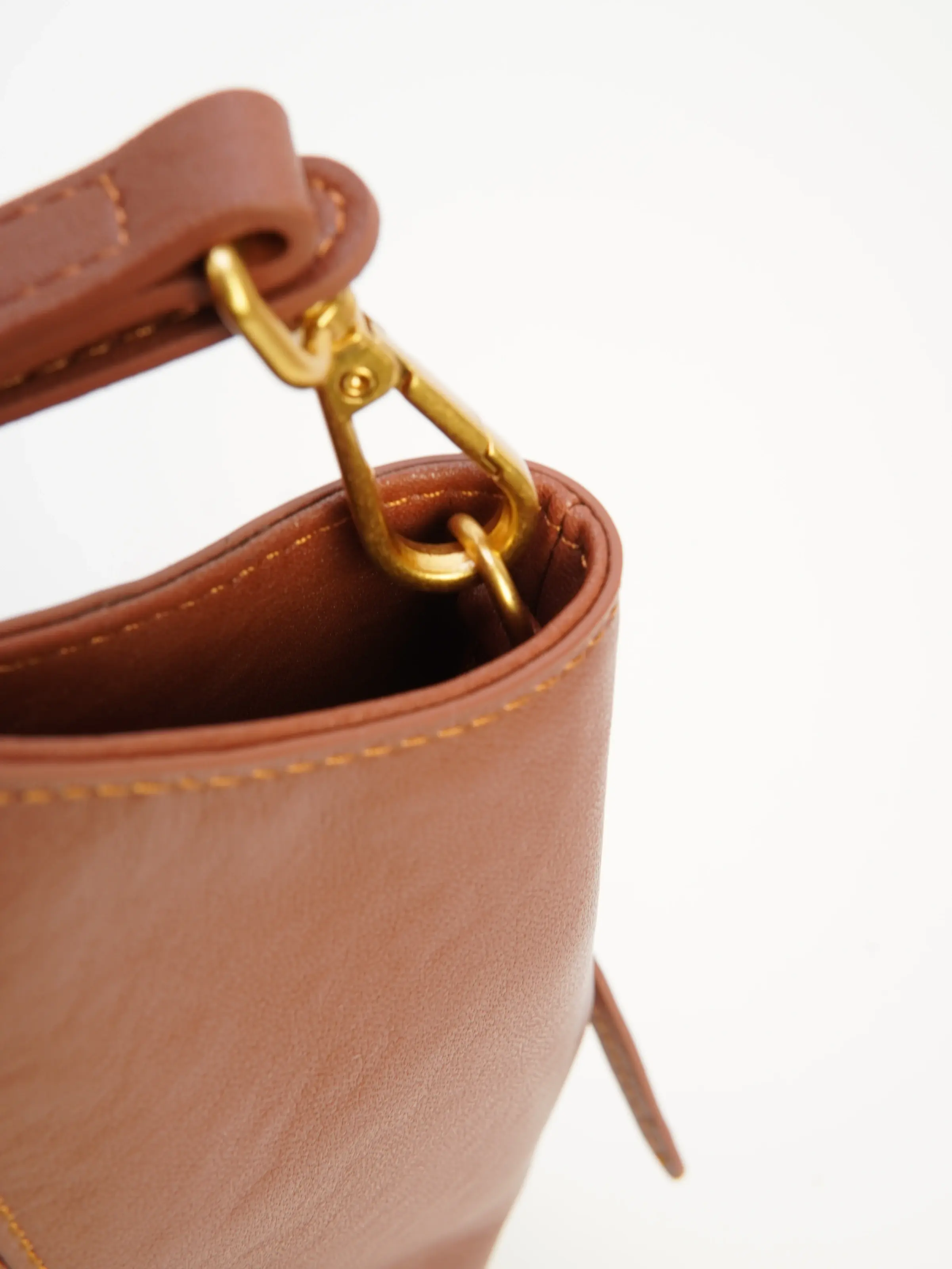 Close view of Nora strap clasp and side attachment