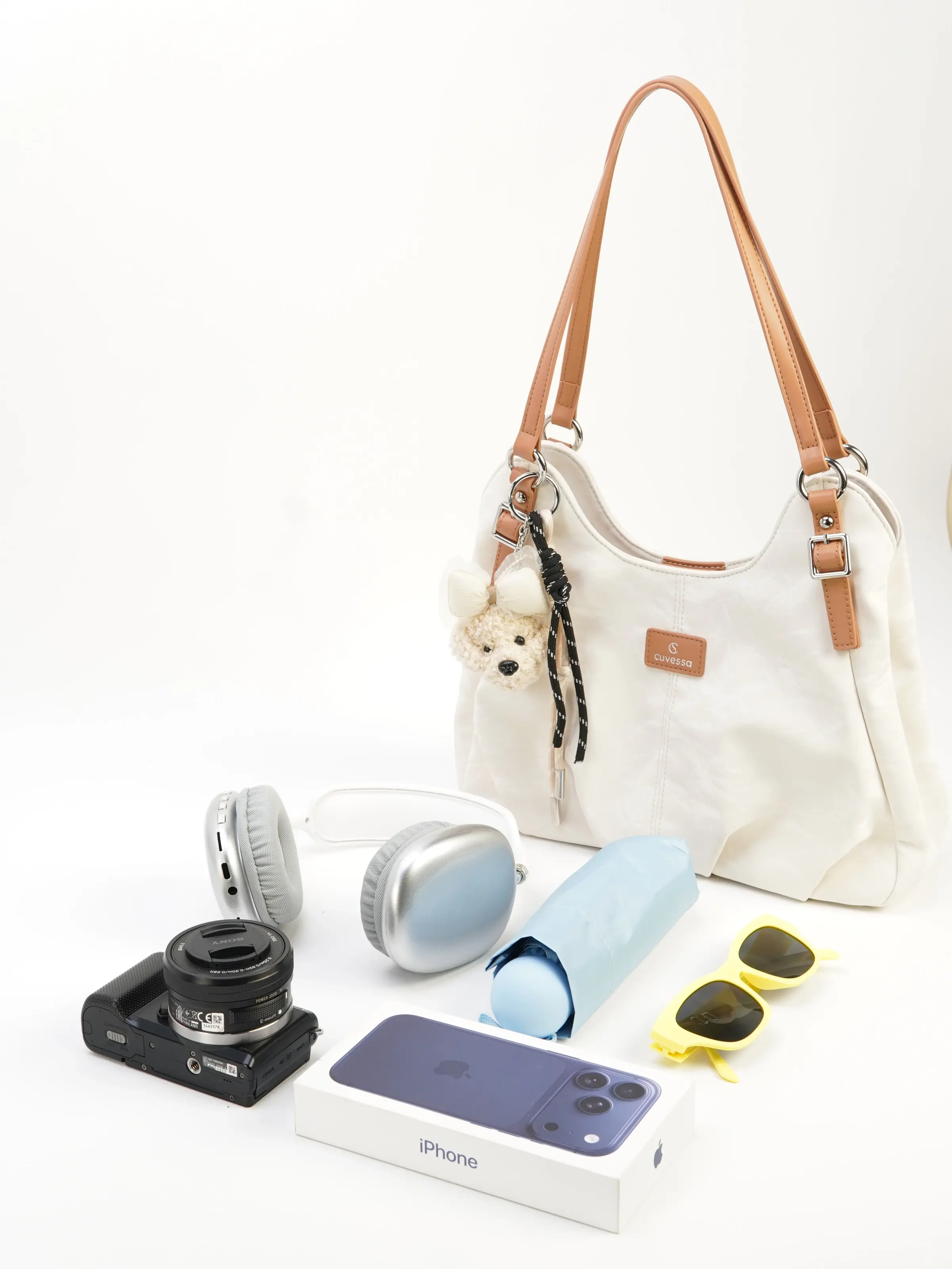 Elia ivory shoulder bag photographed with everyday objects