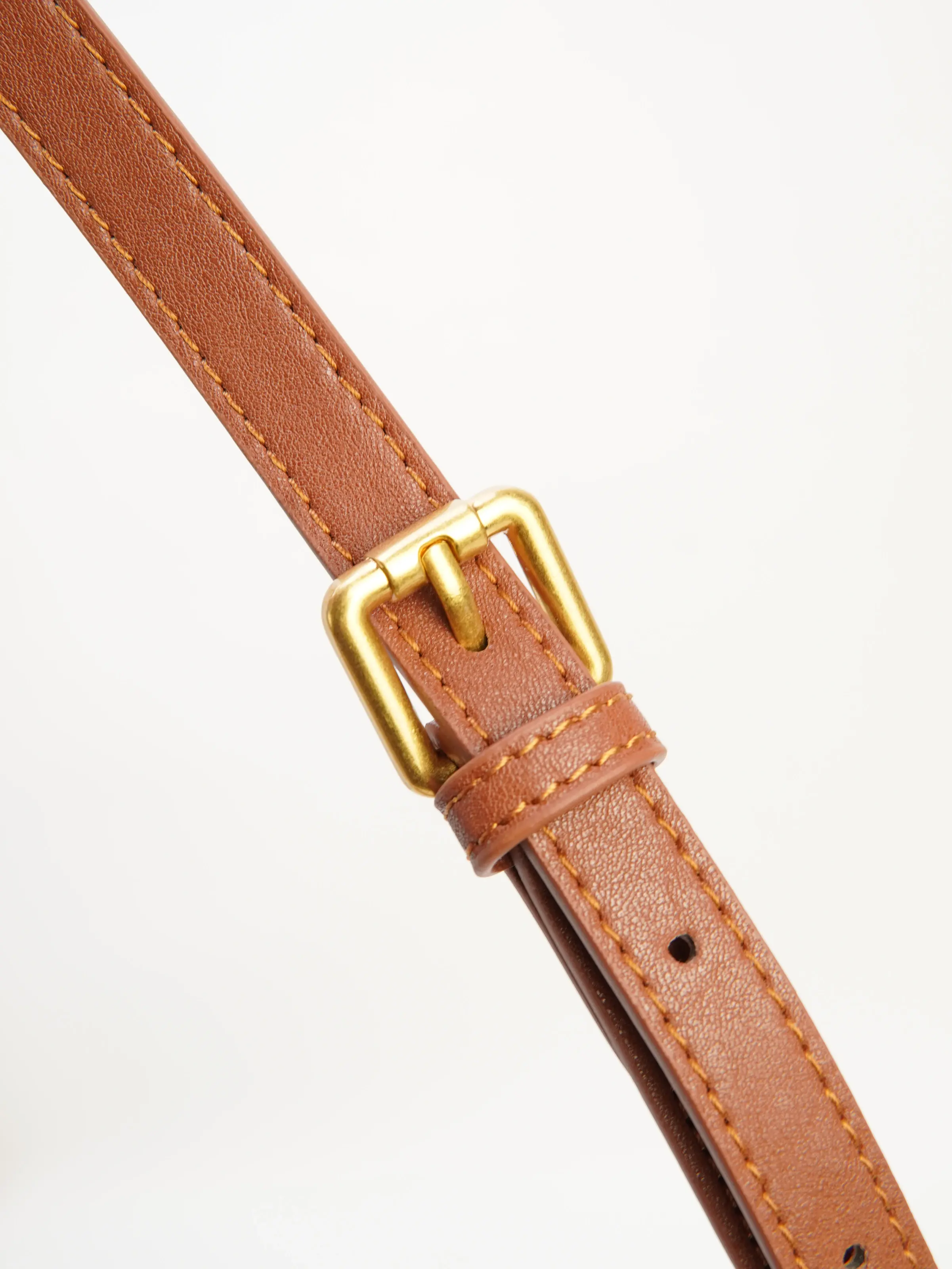 Close view of Nora strap buckle and adjustment holes
