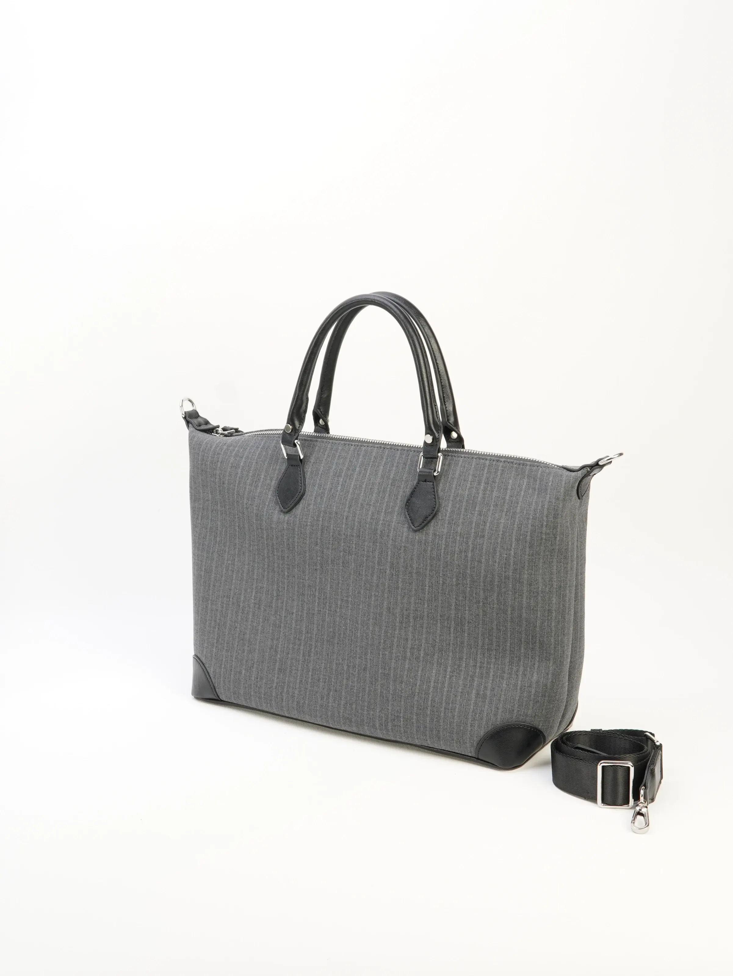 Ellis gray zip tote bag front view with longer strap photographed beside it