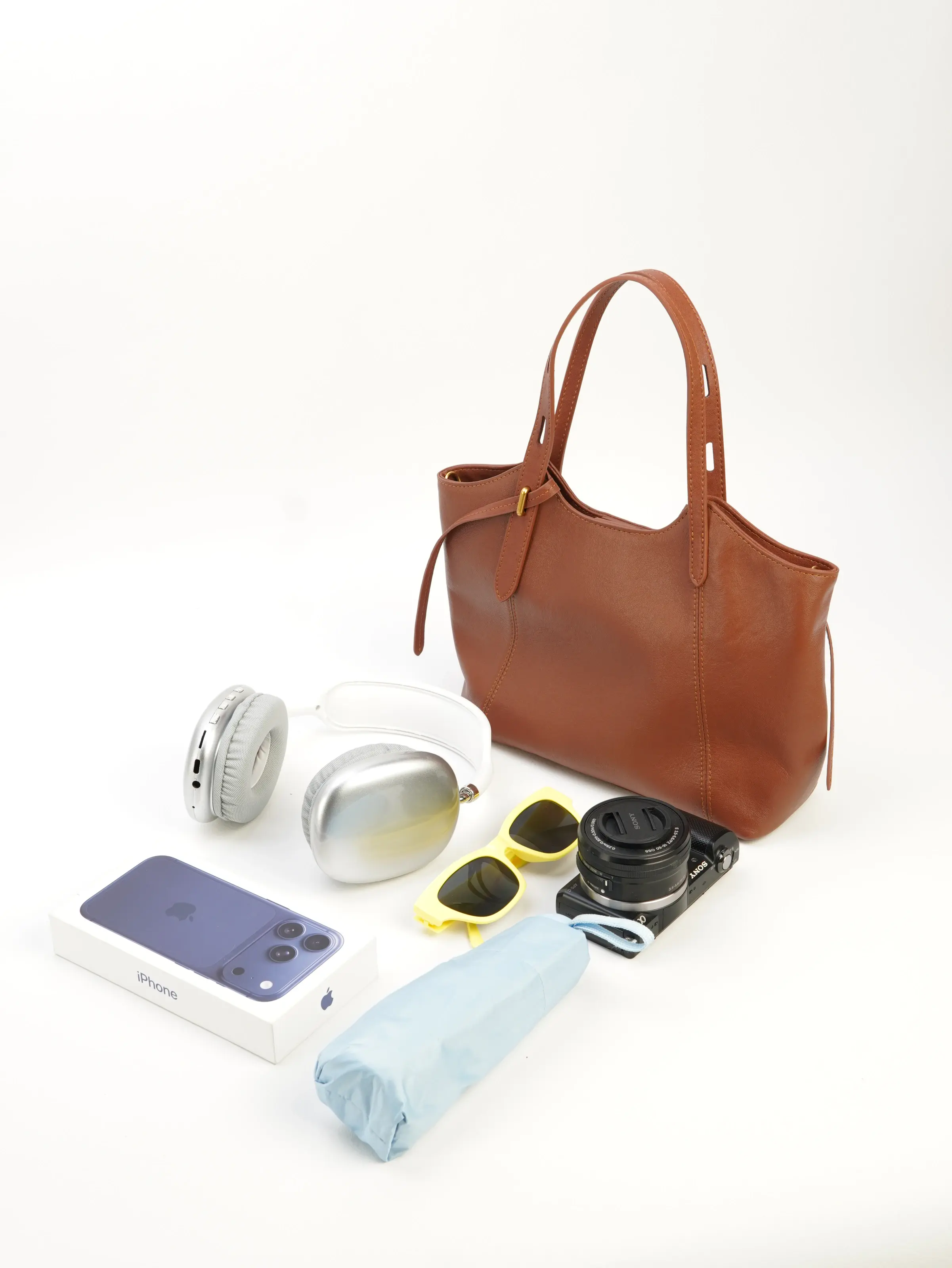 Nora cognac tote bag photographed with everyday objects