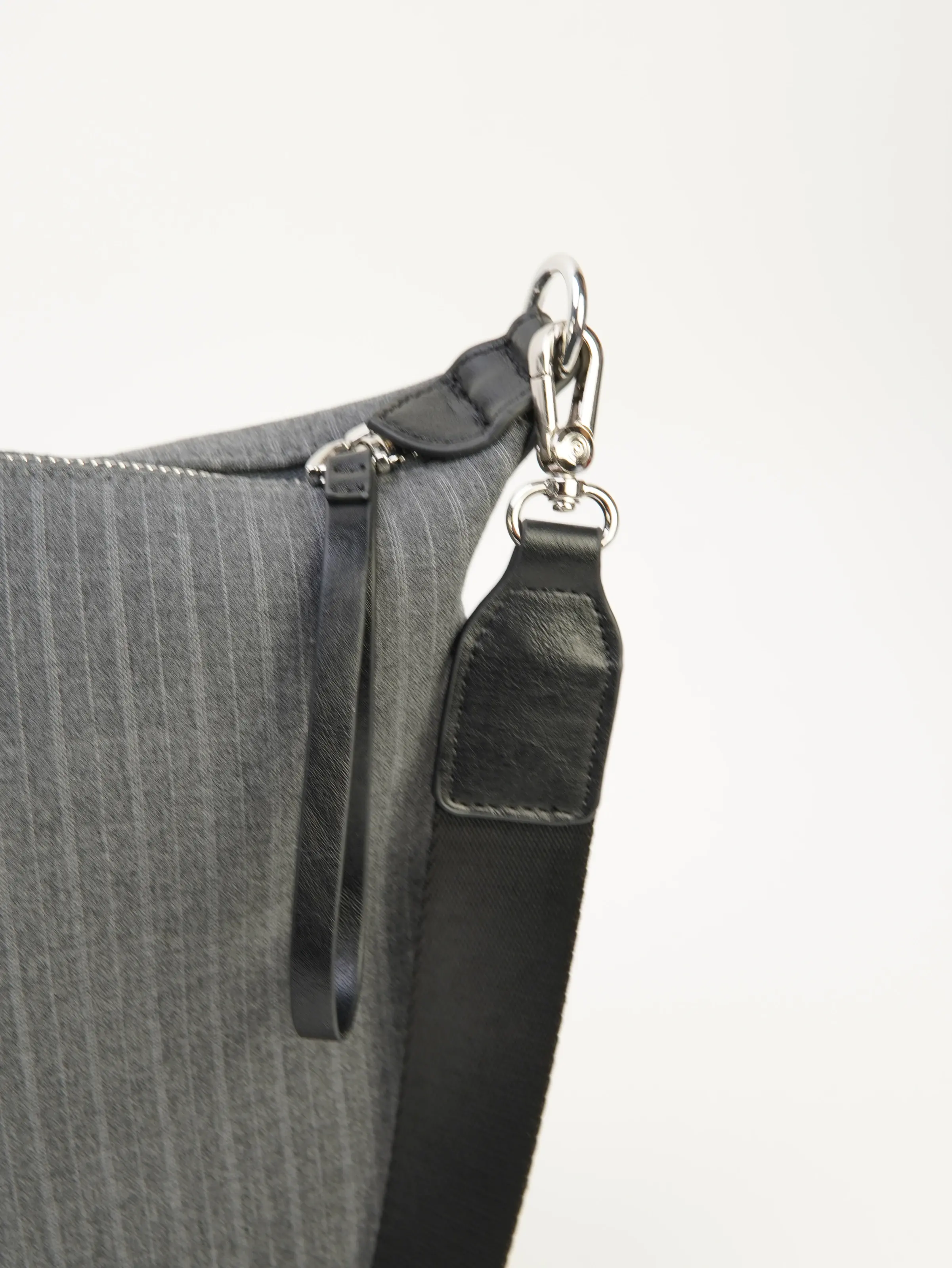 Close view of Ellis longer strap clasp and top zipper
