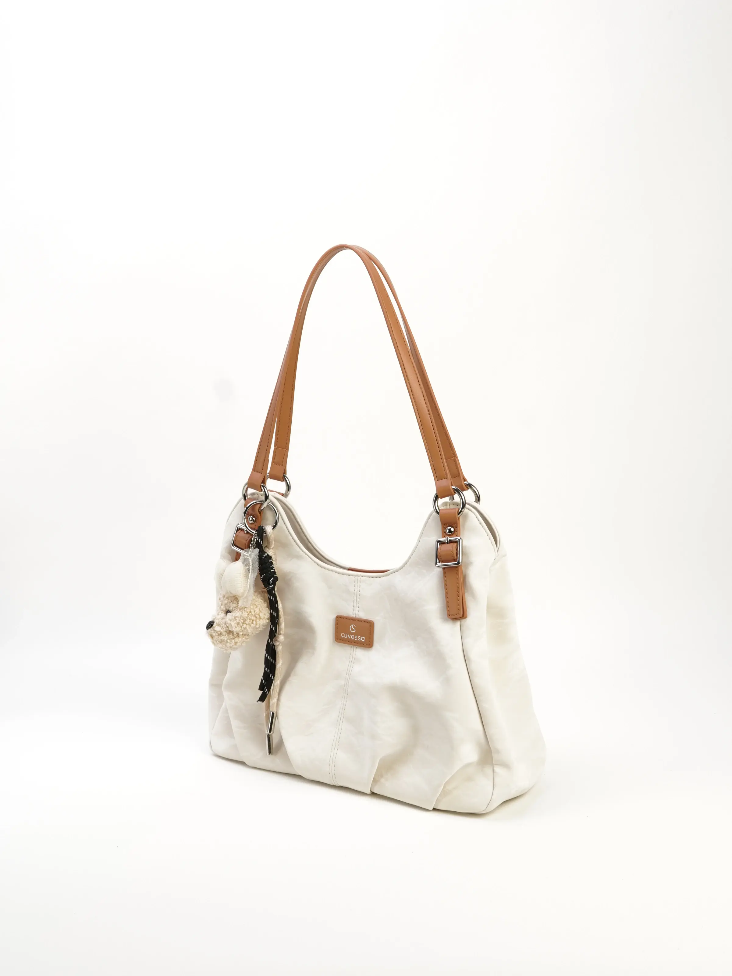 Elia ivory slouch shoulder bag with tan handles, front three-quarter view