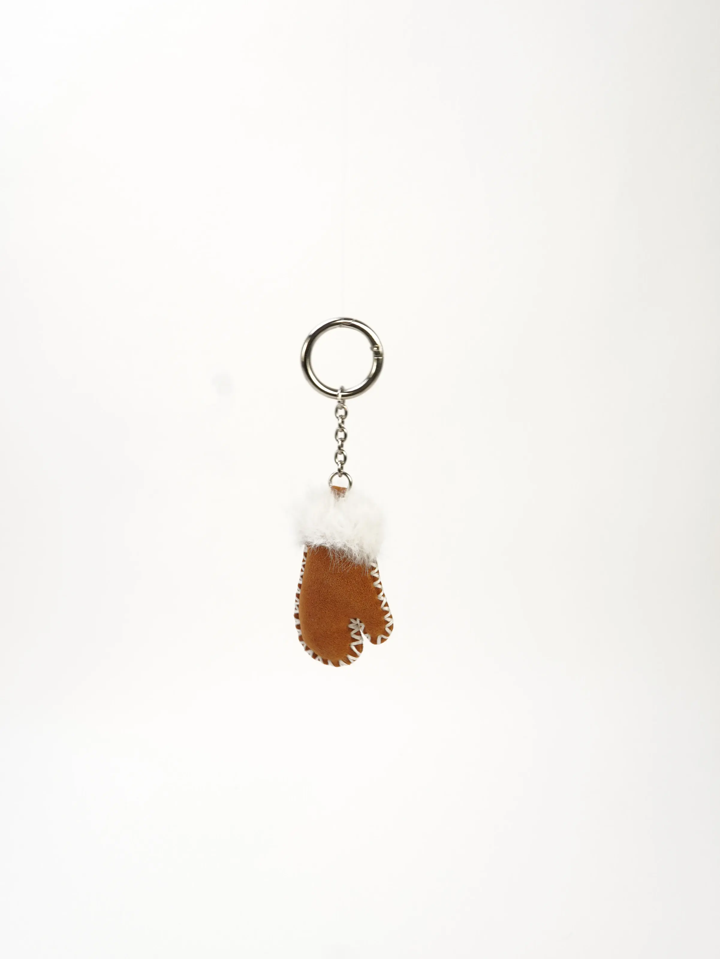 Milo Mitten Bag Charm showing its brown mitten shape and white trim
