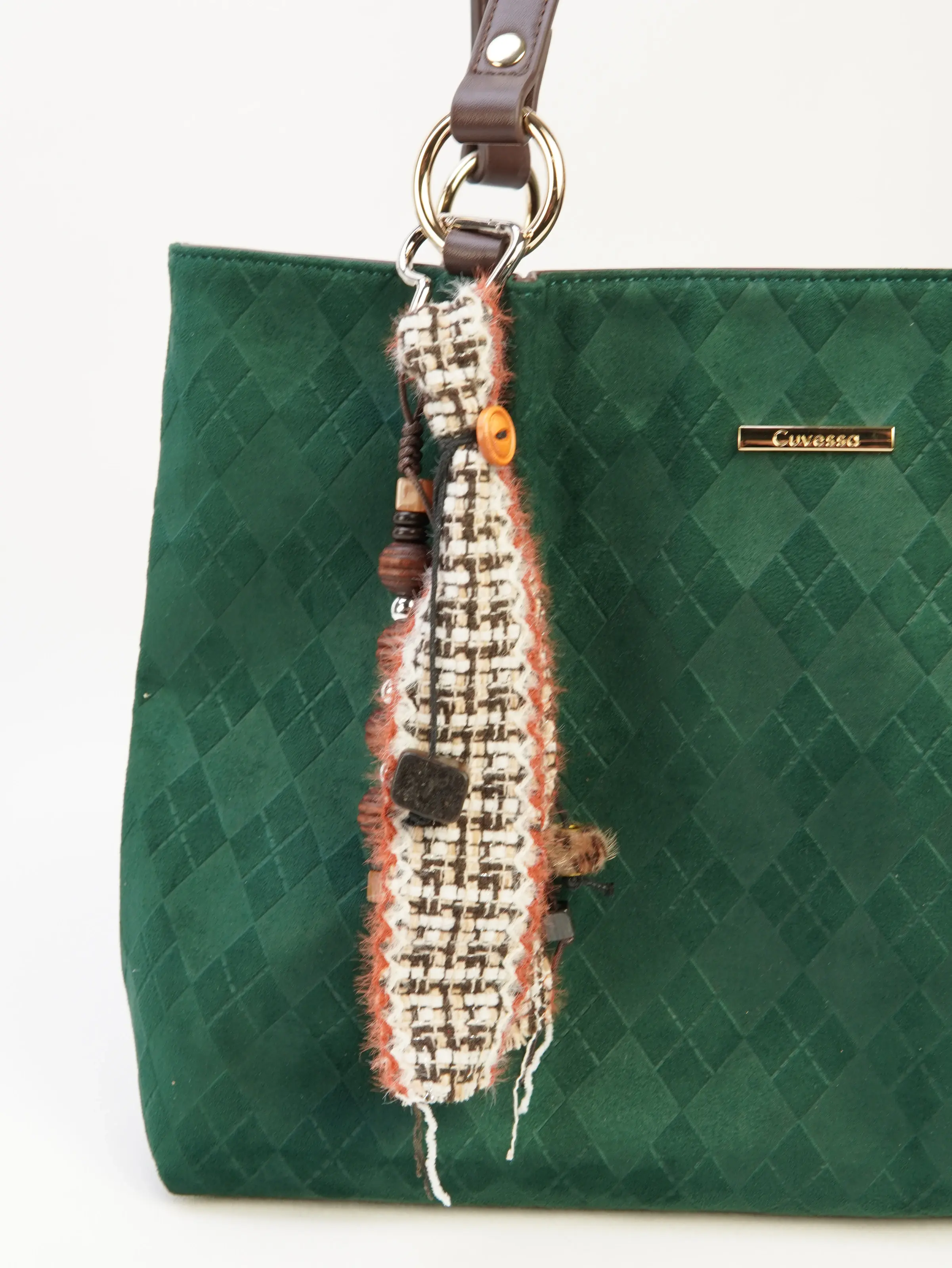 Rue Ribbon and Bead Bag Charm photographed on a green tote bag