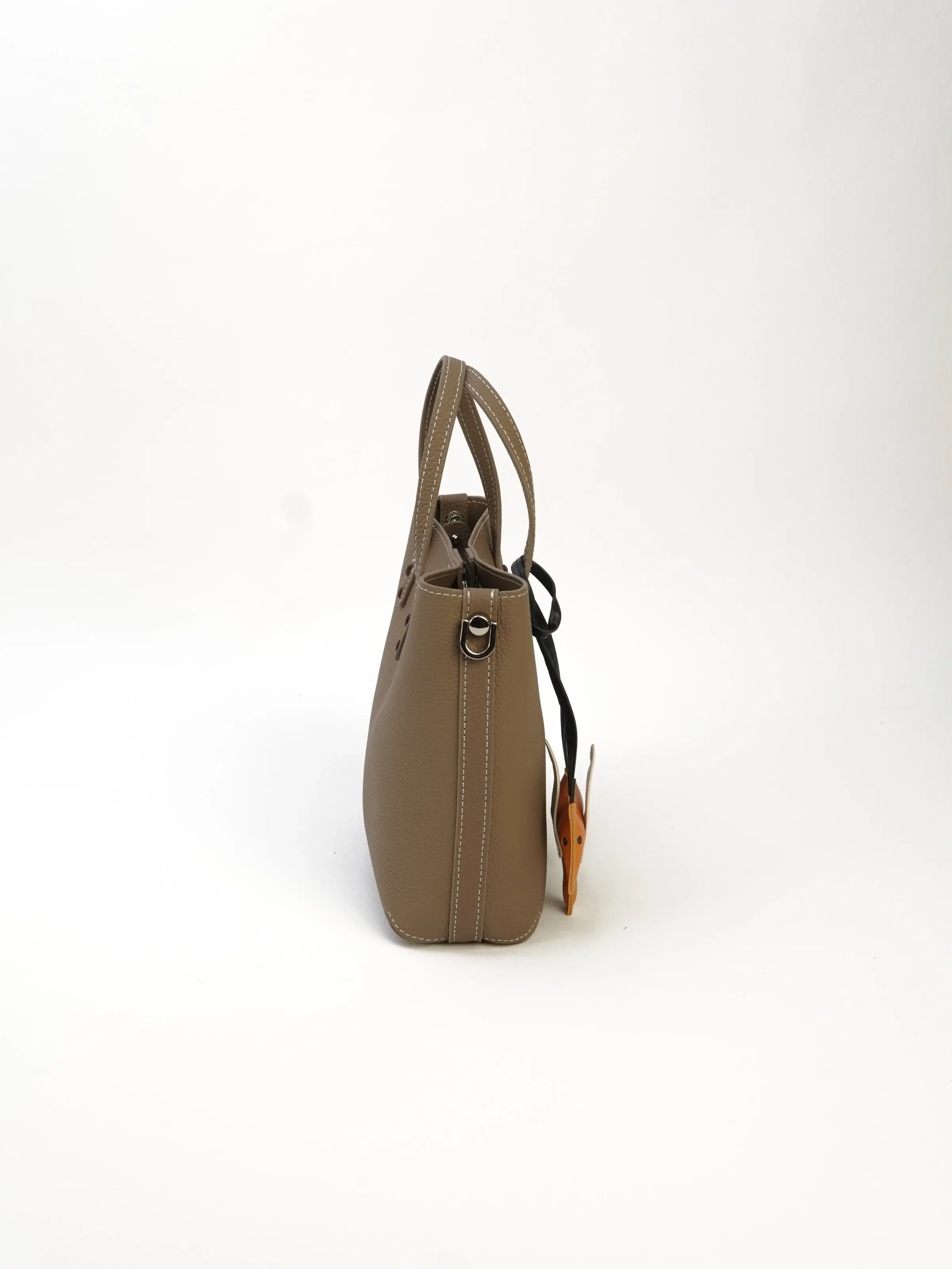 Side profile of the Lena taupe top-handle tote bag